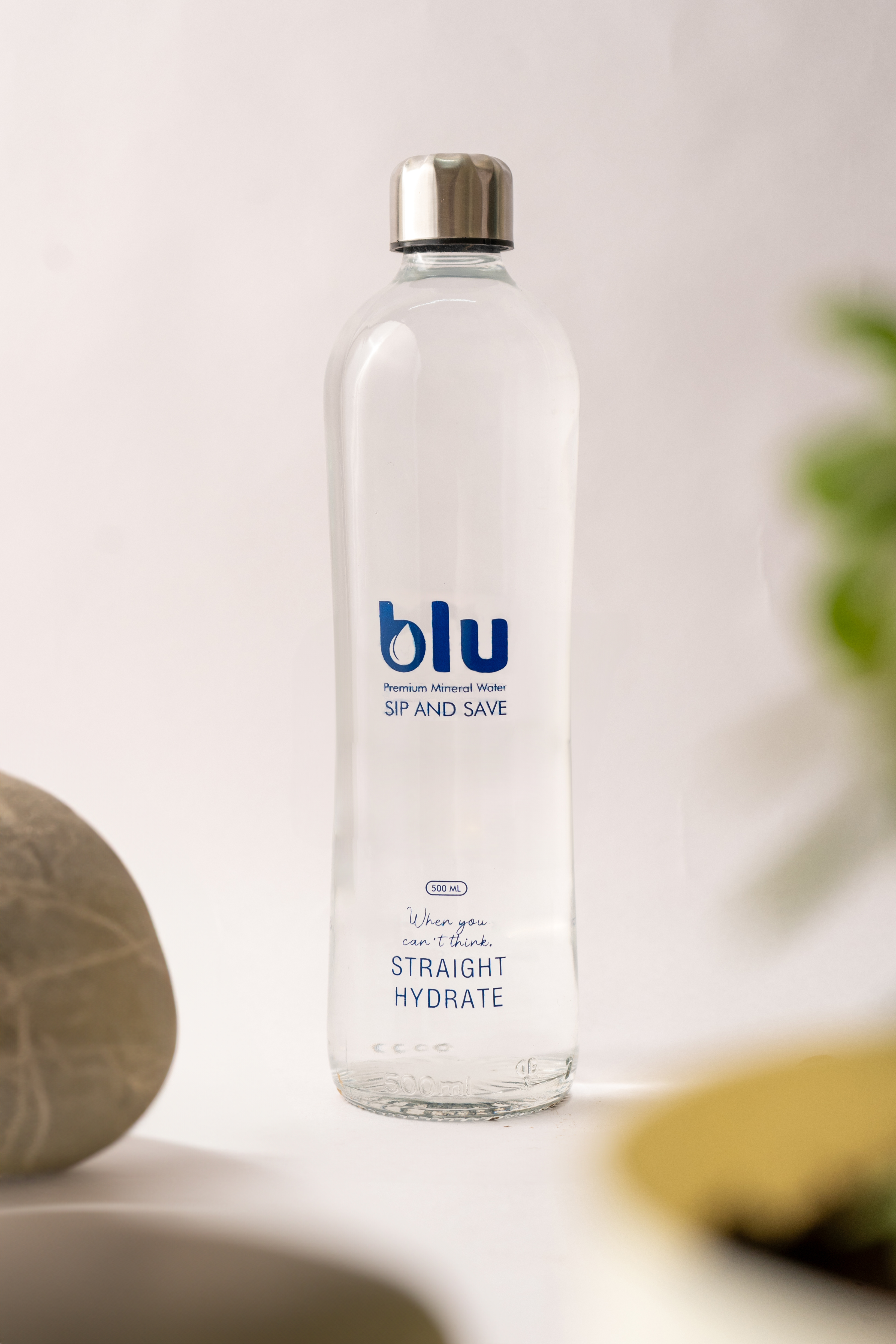 Blu Premium 500ml glass bottle in tropical foliage